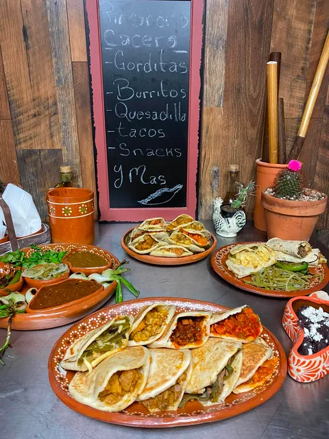 Full spread of Rinconcito Casero's handmade Mexican dishes on traditional clay plates
