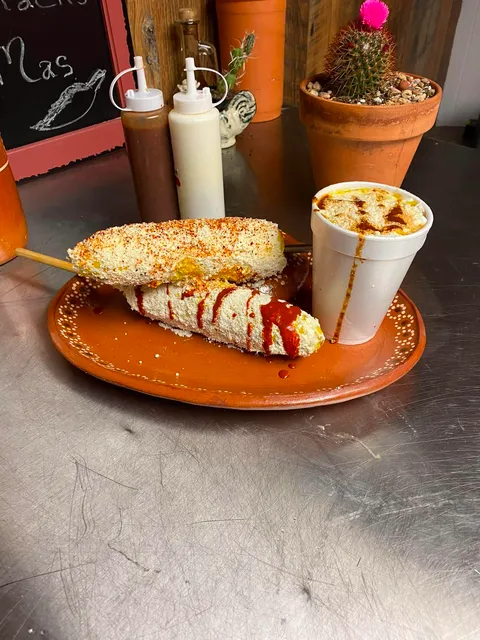 Grilled elote on a stick and elote en vaso — both loaded with mayo, cheese, chili and lime